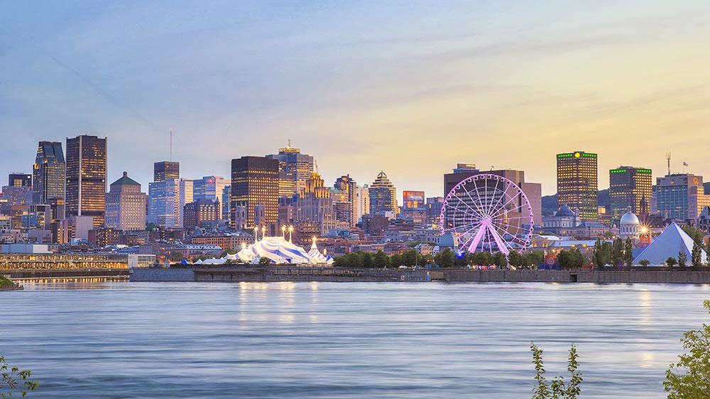 Montreal skyline and St Lawrence River at dusk in winter.