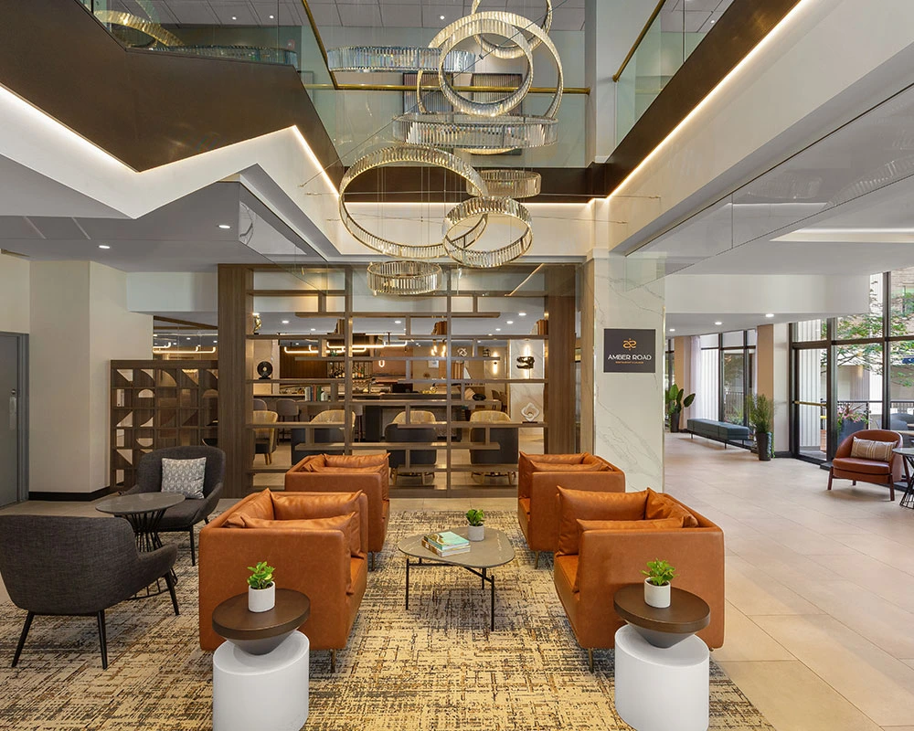 Newly renovated lobby at the Holiday Inn & Suites Vancouver Downtown, featuring contemporary seating, modern décor, and a view into Amber Road Restaurant & Lounge in downtown Vancouver.